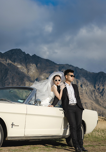 Enchanting Pre-Wedding Photoshoot in Queenstown, New Zealand: Vintage Car, White Horse, and Helicopter amidst Snow-Capped Mountains