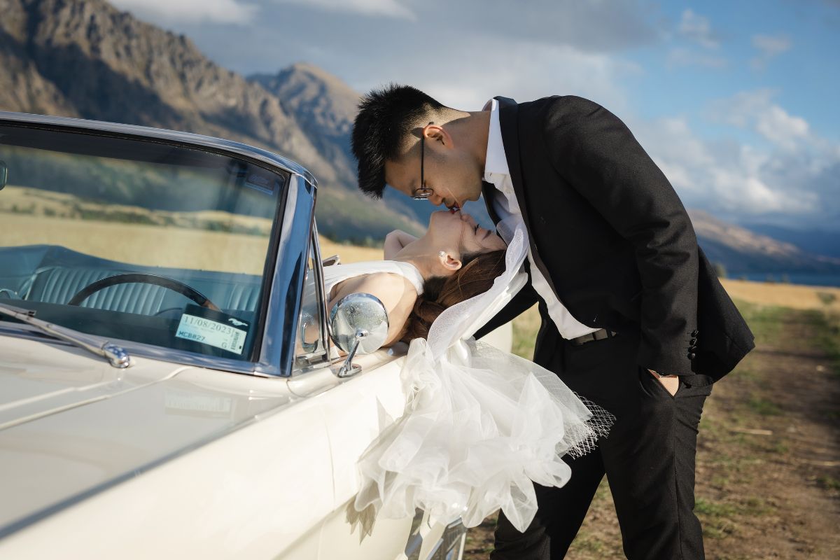 Enchanting Pre-Wedding Photoshoot in Queenstown, New Zealand: Vintage Car, White Horse, and Helicopter amidst Snow-Capped Mountains by Fei on OneThreeOneFour 7