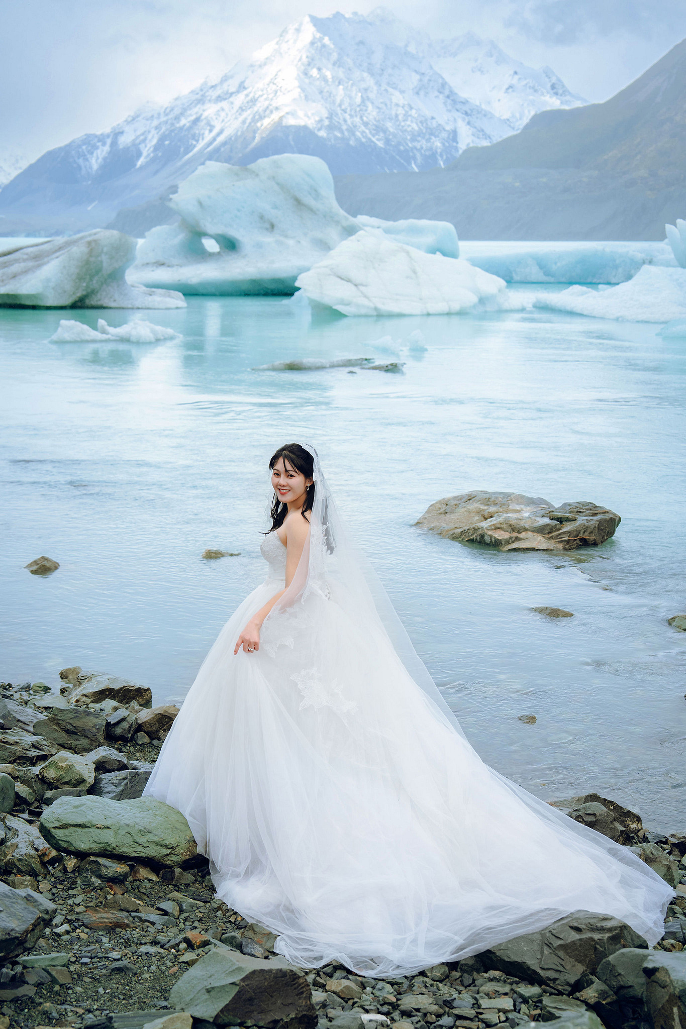 New Zealand Pre-Wedding Photoshoot | Lake Tekapo, Mount Cook, Tasman Glacier & Lake Wakatipu at Glacier Lake pre-wedding photo